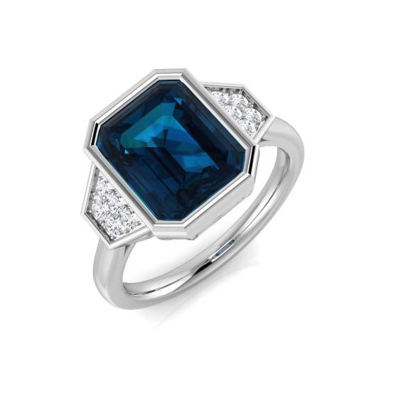 Emerald and Round Cut Blue Topaz Side Stone Ring